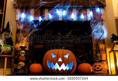 Haunted Halloween Fireplace theme with lights pumpkins and cobwebs