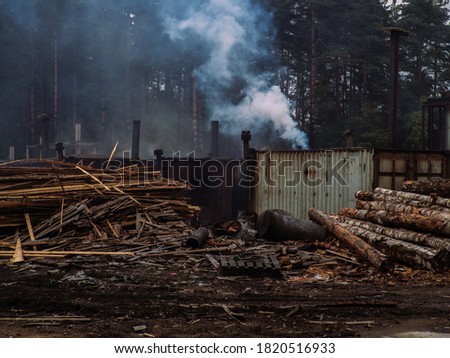 Manufacture of woods pellet. Close-up photo of equipment. Woodworking timber industry: machines and equipment for pressing and cutting sawn timber. Smoke forest