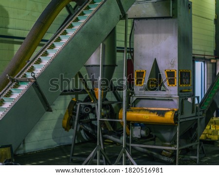 Manufacture of wood pellets. Close-up photo of equipment. Woodworking timber industry: machines and equipment for pressing and cutting sawn timber. Conveyor