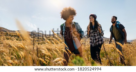 Group of friends on country walk. Young people hiking in countryside. Royalty-Free Stock Photo #1820524994