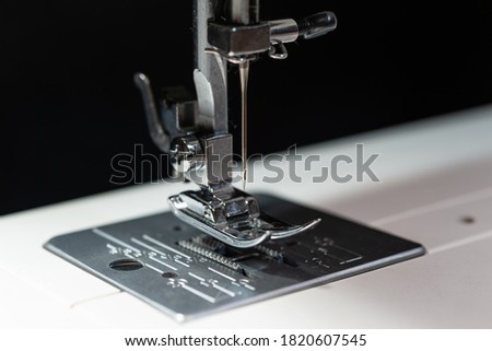  Close up photo of a modern sewing machine Presser Foot with a needle