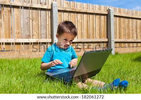 Boy playing on laptop