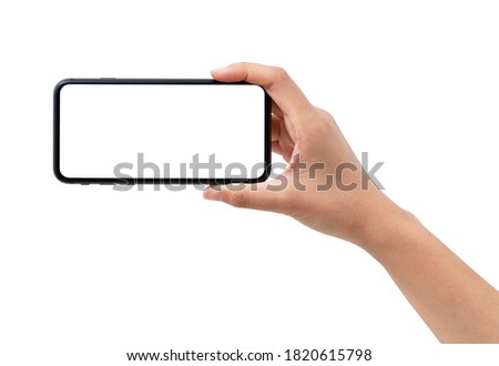A woman's hand holding a black smartphone. Royalty-Free Stock Photo #1820615798
