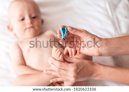 Nail clipping for a small child. Mom's little feet and hands. Pedicure. concept cleaning wipe, pure, clean.