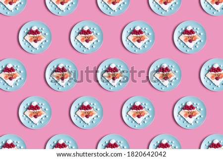 Children's breakfast or lunch, toast stylized in the form of santa claus with raspberries, strawberries, cottage cheese and marshmello. Pattern New Year's table decoration.