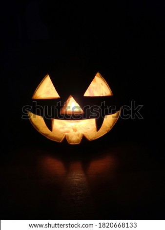 Halloween fiery eyes and mouth pumpkin in the dark