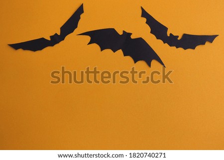 Halloween and decoration concept orange background with bats.