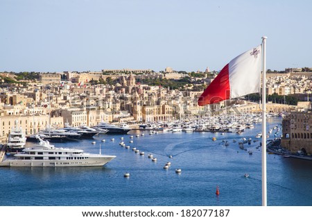fantastic city landscape on the seaside in Malta.Republic of Malta flag waving in Valletta Royalty-Free Stock Photo #182077187