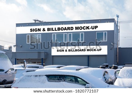 Mock up two blank horizontal outdoors signboard with clipping path on panel of office, Empty space for insert advertising graphic design company name, many cars in car park covered with snow on winter
