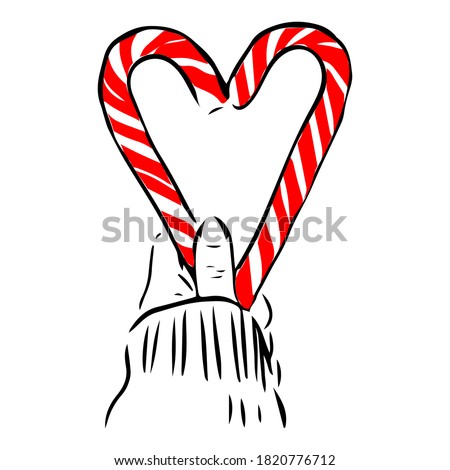 Red striped heart shaped lolipop.Womans hand holding a lolipop