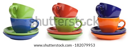 Set of multicolored cups and saucers, isolated on white background