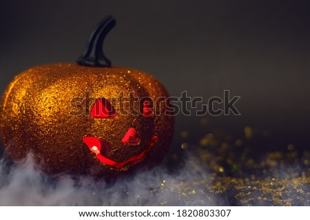 Halloween. Pumpkin head with red eyes on a dark gray background. Jack lantern. Smoke. Copy space.