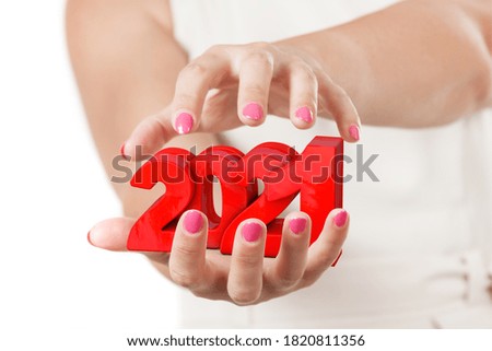 Two Woman Hands Protecting 2021 New Year Sign on a white background.