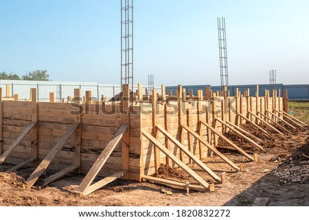 close-up of the hous wooden formwork anchored to the foundation. Building a house in the countryside. Royalty-Free Stock Photo #1820832272