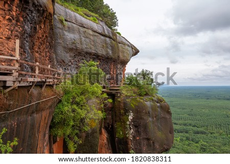 A wooden bridge on a high cliff,Phu Thok or Chetiyakiri Temple Beautiful mountain landscape with rocky cliffs,Bueng Kan Province,Thailand

