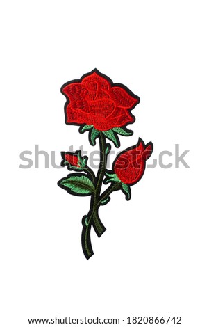 Red rose embroidered patch isolated on white background. Elegant decoration for clothing repair or custom design.