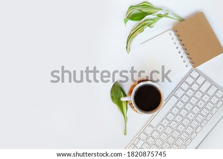 Office desk top view. Workspace with blank clip board, keyboard, office supplies, pencil, coffee cups on a white background. Place for text