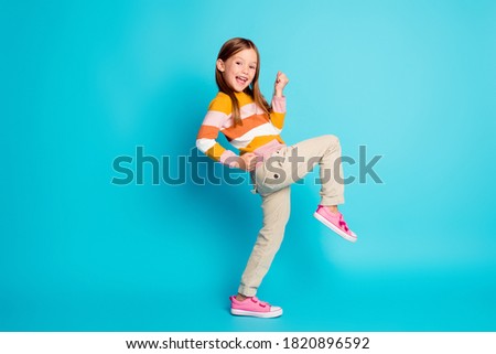 Full length body size profile side view of her she nice attractive pretty lucky glad cheerful cheery girl celebrating great success isolated over bright vivid shine vibrant blue color background Royalty-Free Stock Photo #1820896592