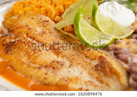 A closeup view of grilled white fish.