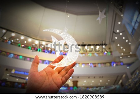 A man hand touching Moon star light LED decoration