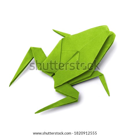 Origami paper frog on white background close up