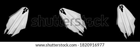 Halloween banner. White ghosts made from white sheets flying on black background. Halloween decoration