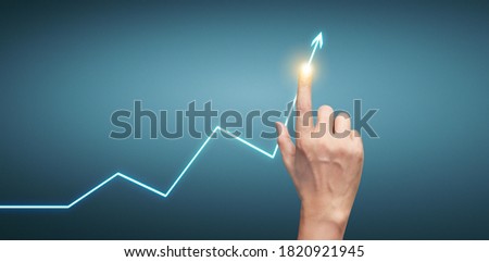 Hand touching  graphs of financial indicator and accounting market economy analysis chart