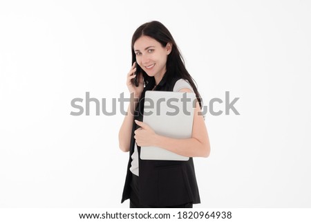 Business woman is haing business call by a smarthphone standing with holding laptop in her hand. Isolate white background