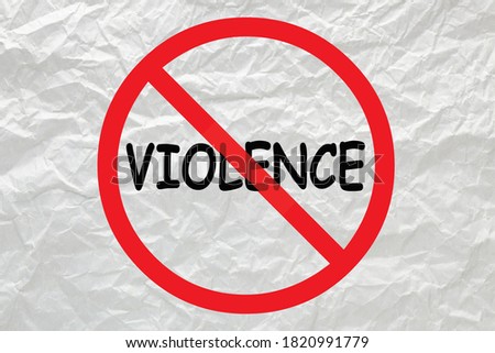 Stop violence sign on white crumpled paper.