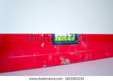Building tool level. Red water level tool isolated on white background. Concept. Copy space.