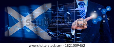 Businessman touching data analytics process system with KPI financial charts, dashboard of stock and marketing on virtual interface. With Scotland flag in background.