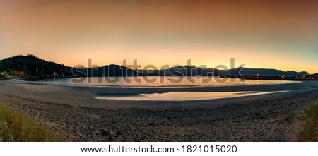 Panoramic beach sunset sunrise view at Porto de Espasante in the Galicia region of Spain. Royalty-Free Stock Photo #1821015020