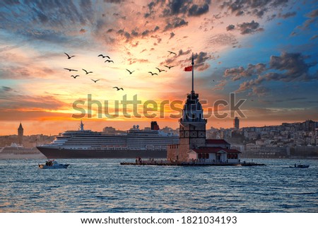 Fiery sunset over Bosphorus with famous Maiden's Tower (Kiz Kulesi) also known as Leander's Tower, symbol of Istanbul, Turkey. Scenic travel background and cruise ship for wallpaper or guide book  Royalty-Free Stock Photo #1821034193