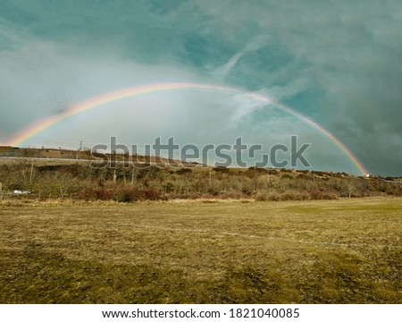 Rainbow after the storm in the field