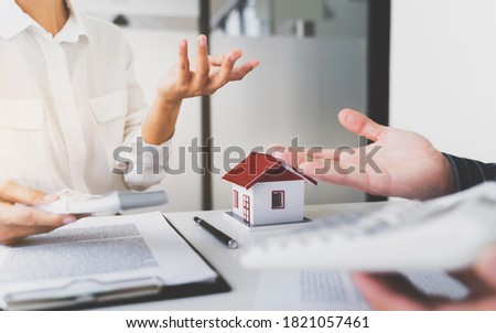 Real estate agent and Customer with contract to buying a house.