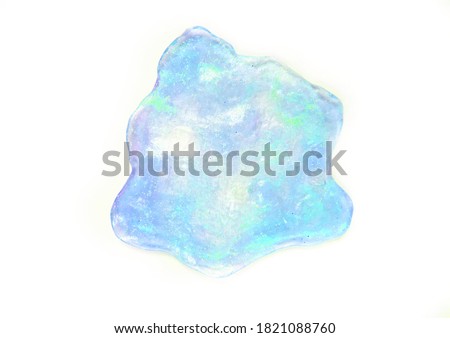     textured neon blue transparent slime with glitter inside. Macro of kids toy slime.   isolated on white background              