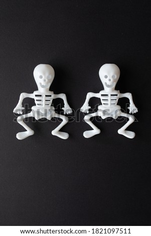 Postcard for Halloween. Human skeletons and on an black background. flat lay with copy space