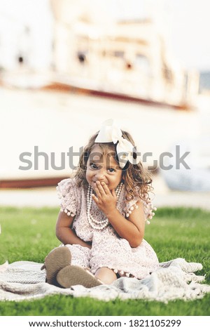 A vertical closeup portrait of an adorable girl outdoors
