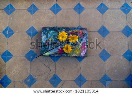 Palette with Painting Material and a Bouquet of Summer Flowers and sunflower.
