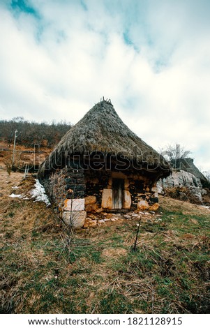 A cabin in the middle of the snowy mountains during winter in asturias with a rural view and trekking refuge