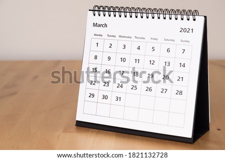 Month page: March in 2021 paper calendar on the wooden table