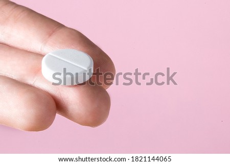 A white pillow in the hand on the fingers palm