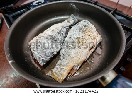 Fish with flour fried in cooking pan with hot oil
