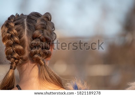 Hairstyle French braid inside out, on the head of a young girl. Royalty-Free Stock Photo #1821189278