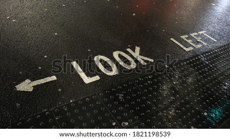 Sign on the ground of London streets on a rainy day
