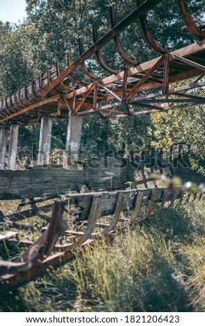 Old abandoned wooden bobsleigh track in summer by daylight
