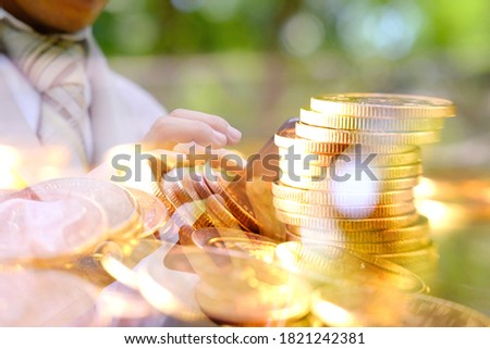 Double exposure, business working a smartphone and golden coins on table background and Business growth strategy of money concept