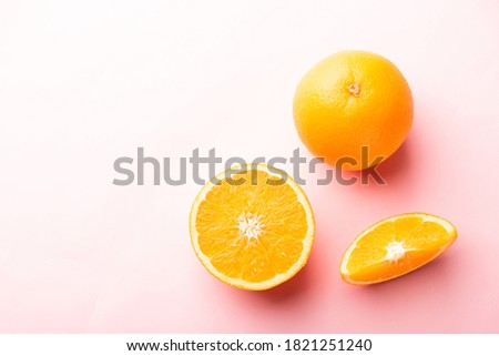 Top view of Fresh half orange fruit slice and full orange in the studio shot isolated on pink background, Healthy food concept