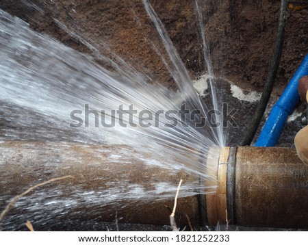 The main pipe is broken or burst pipe and is being repaired Royalty-Free Stock Photo #1821252233
