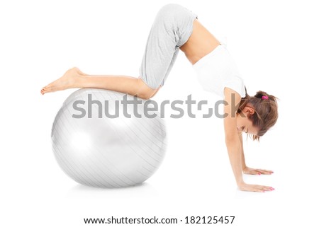 A picture of a fit woman exercising with a ball over white background